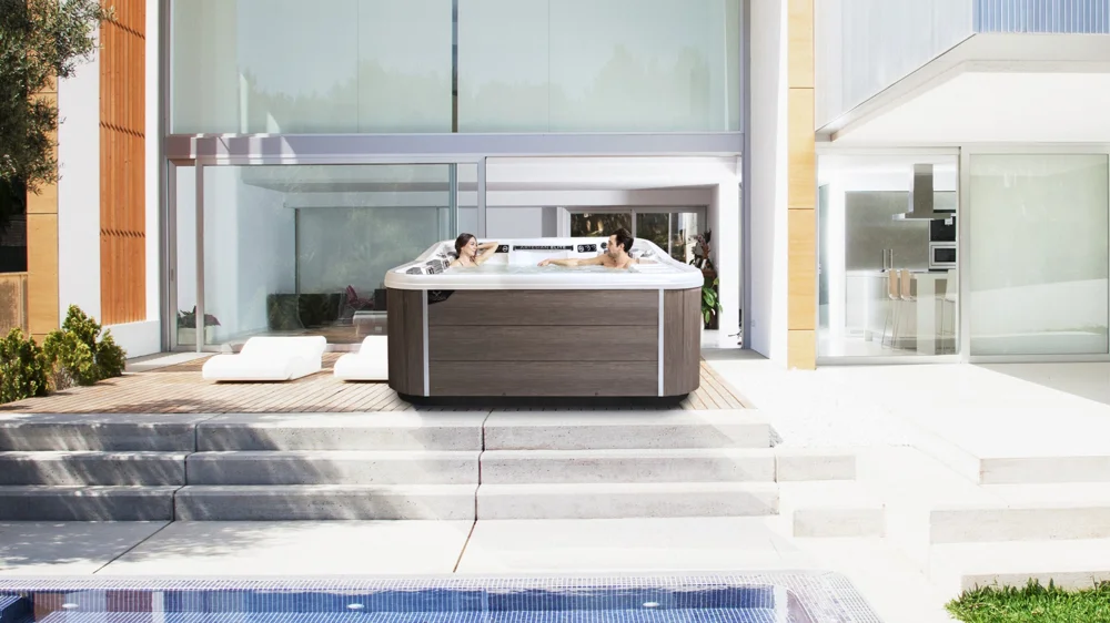 Artesian Spas Piper Glen installed on a backyard patio, official Pelican install photo